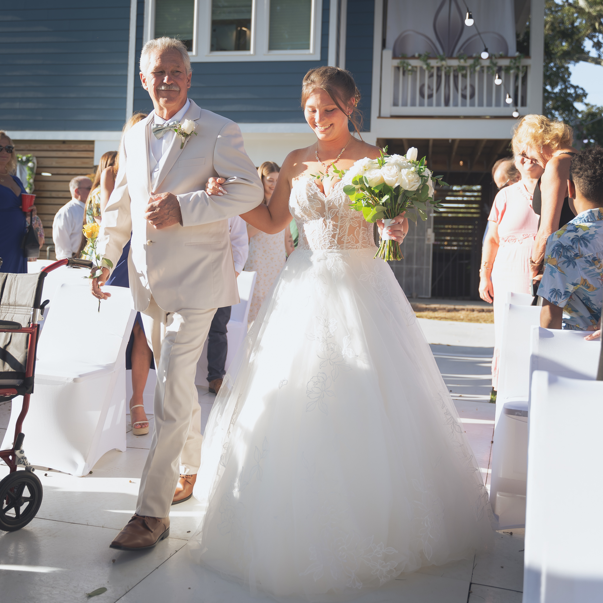 Bride walking down aisle during small intimate wedding. 