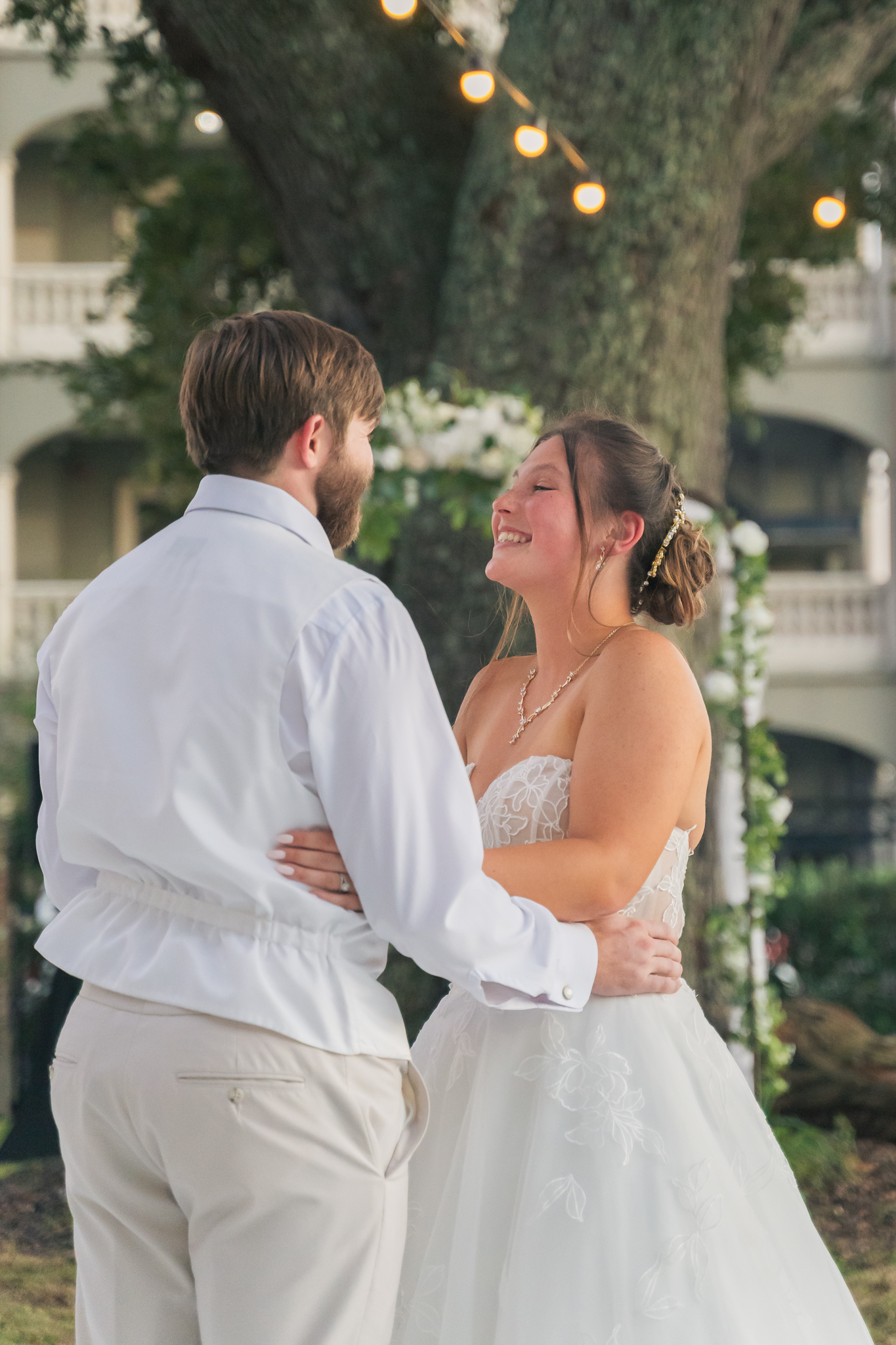 Happy couple laughing during first dance at wedding. 