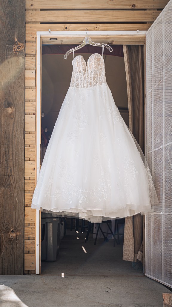 Wedding dress hanging in doorway at Gulfport, MS wedding