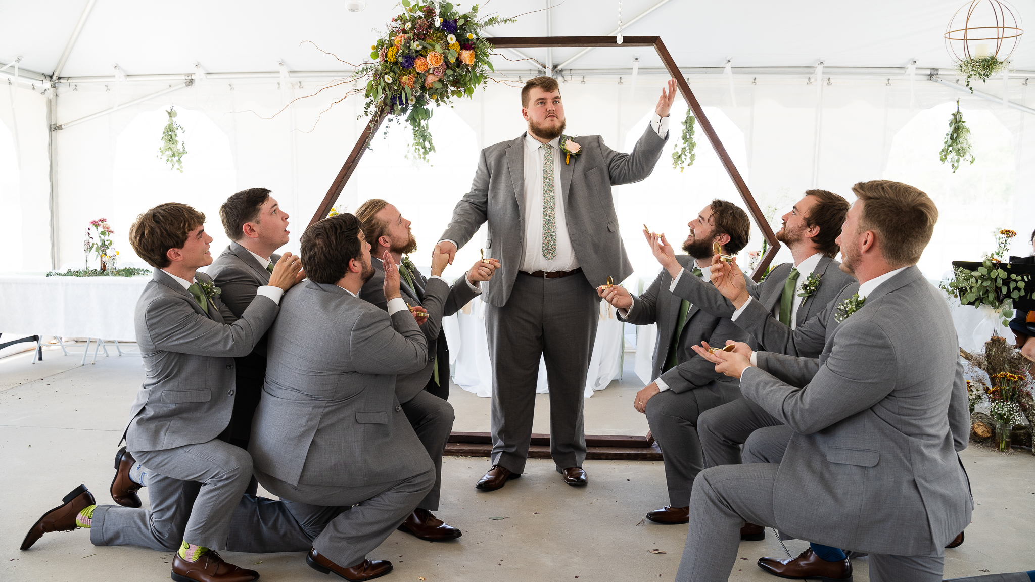 Groom being praised by groomsmen at the alter at a christian wedding