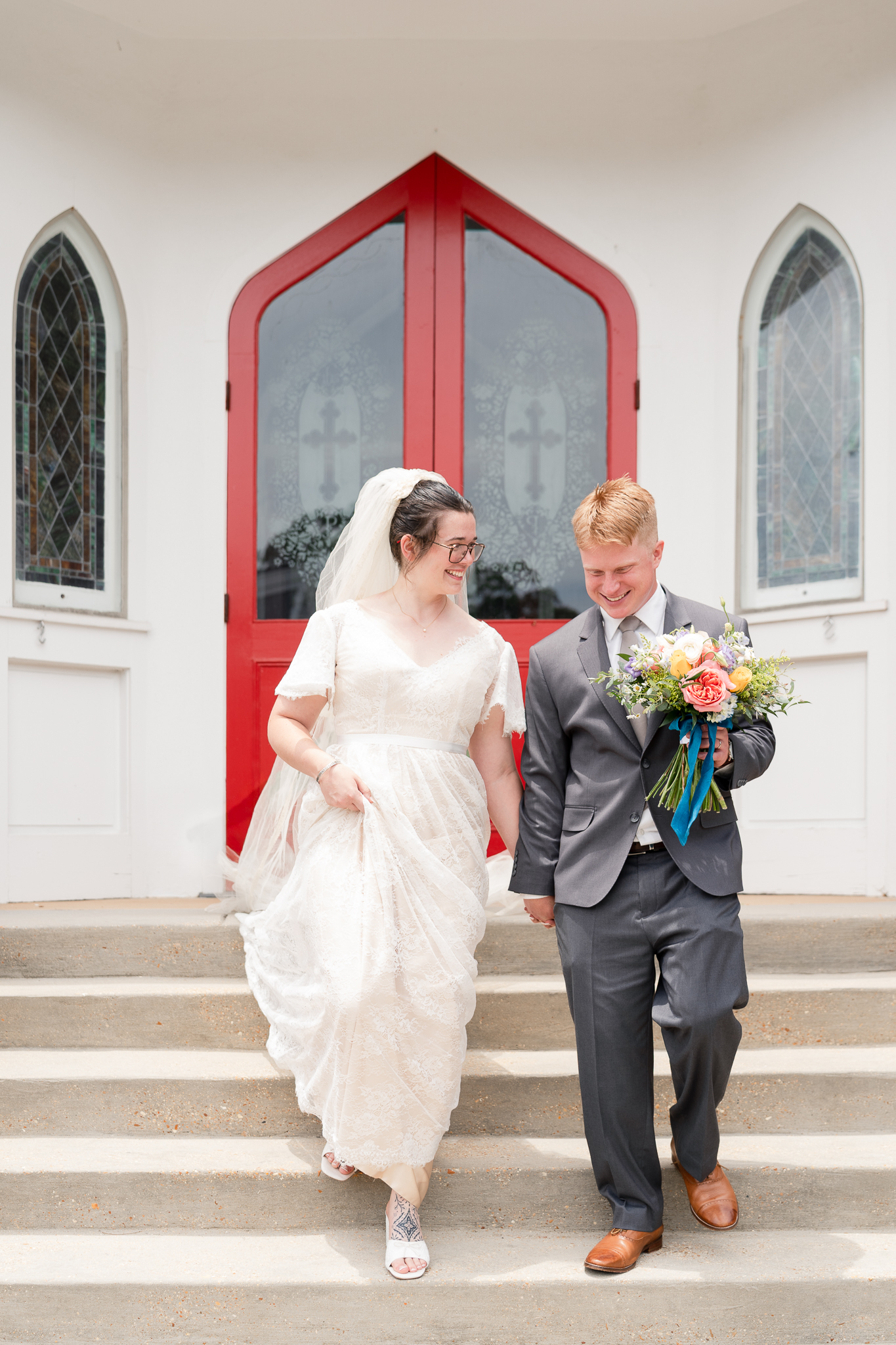 Bride and Groom walking down the steps of the exit of a Mississippi Church in Starkville, MS
