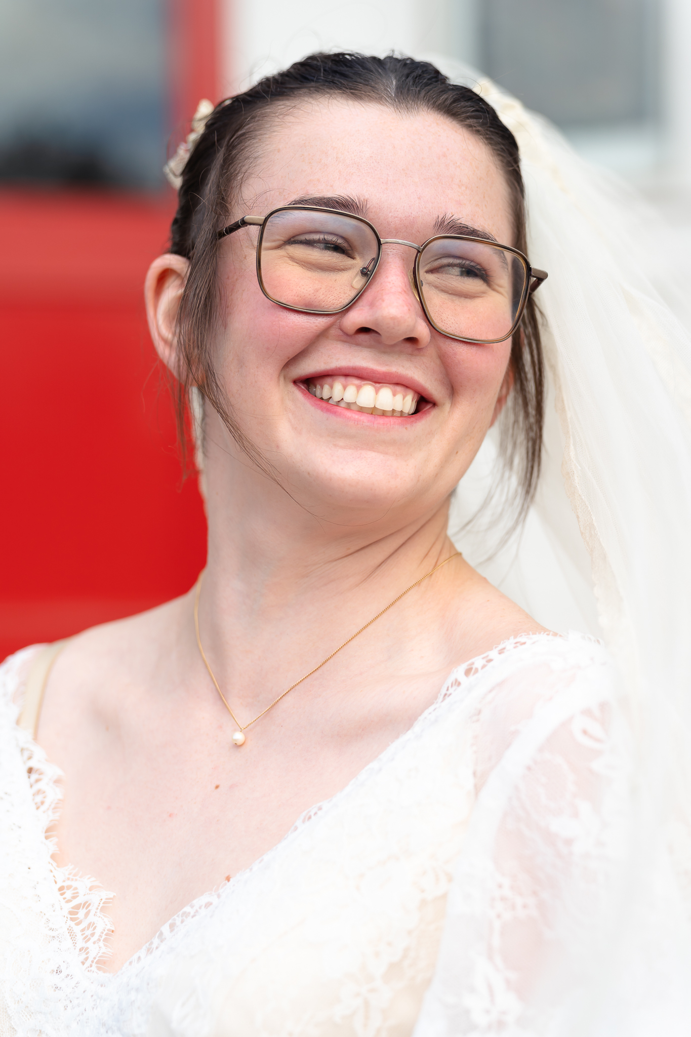 Portrait of Mississippi Bride smiling into the distance with a red church door behind her