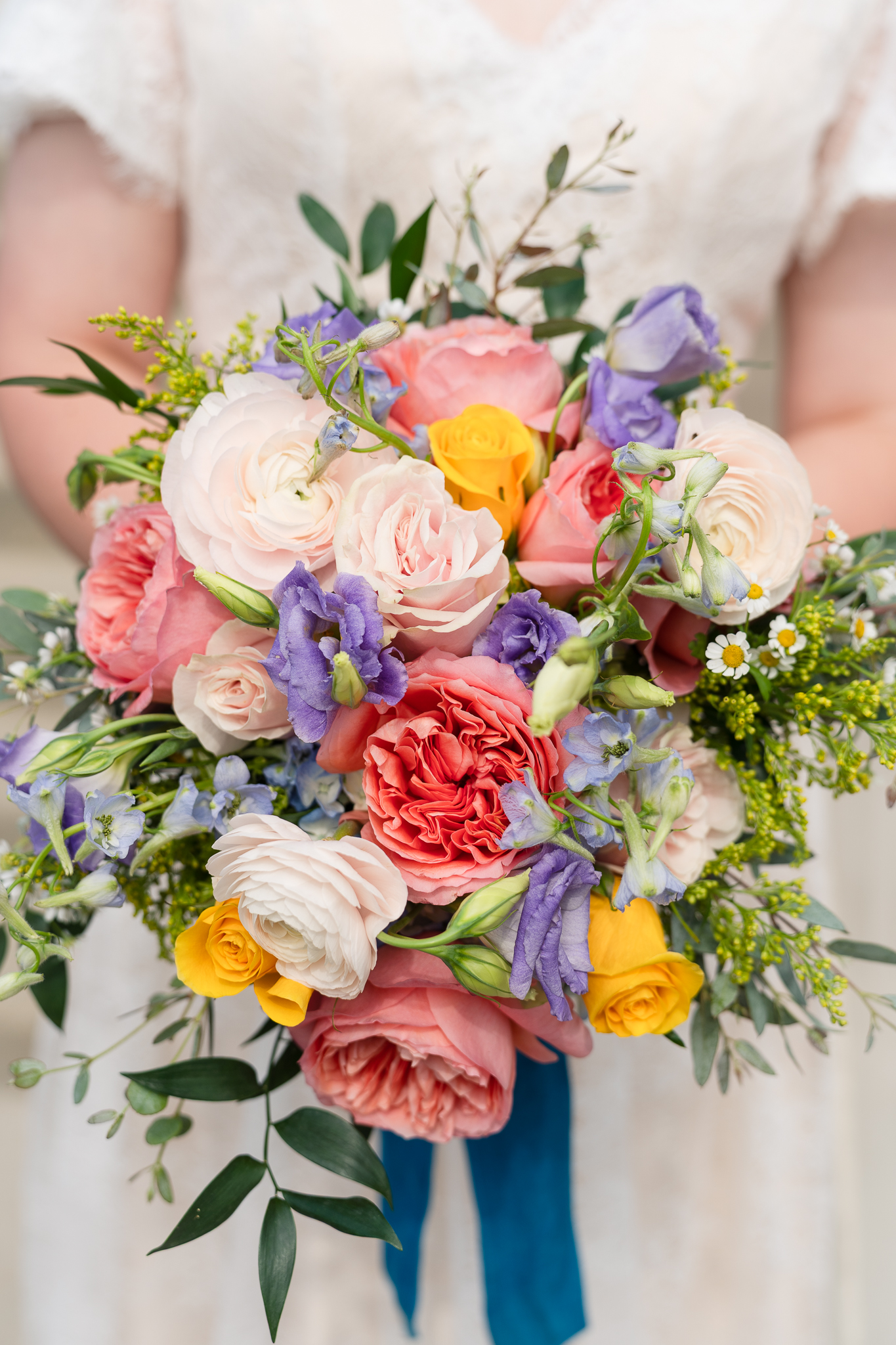 Bride holding wedding florals