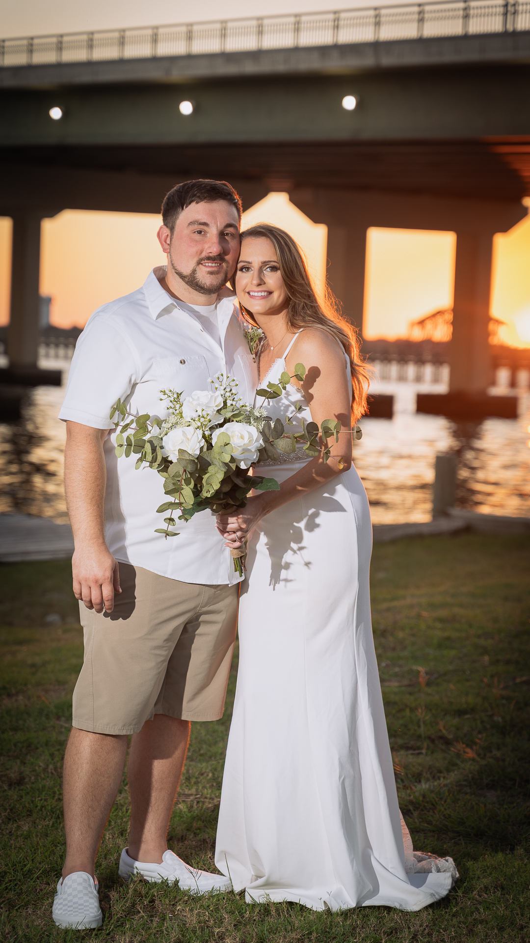 Bride and Groom posing for a sunset portrait on the Mississippi Gulf coast