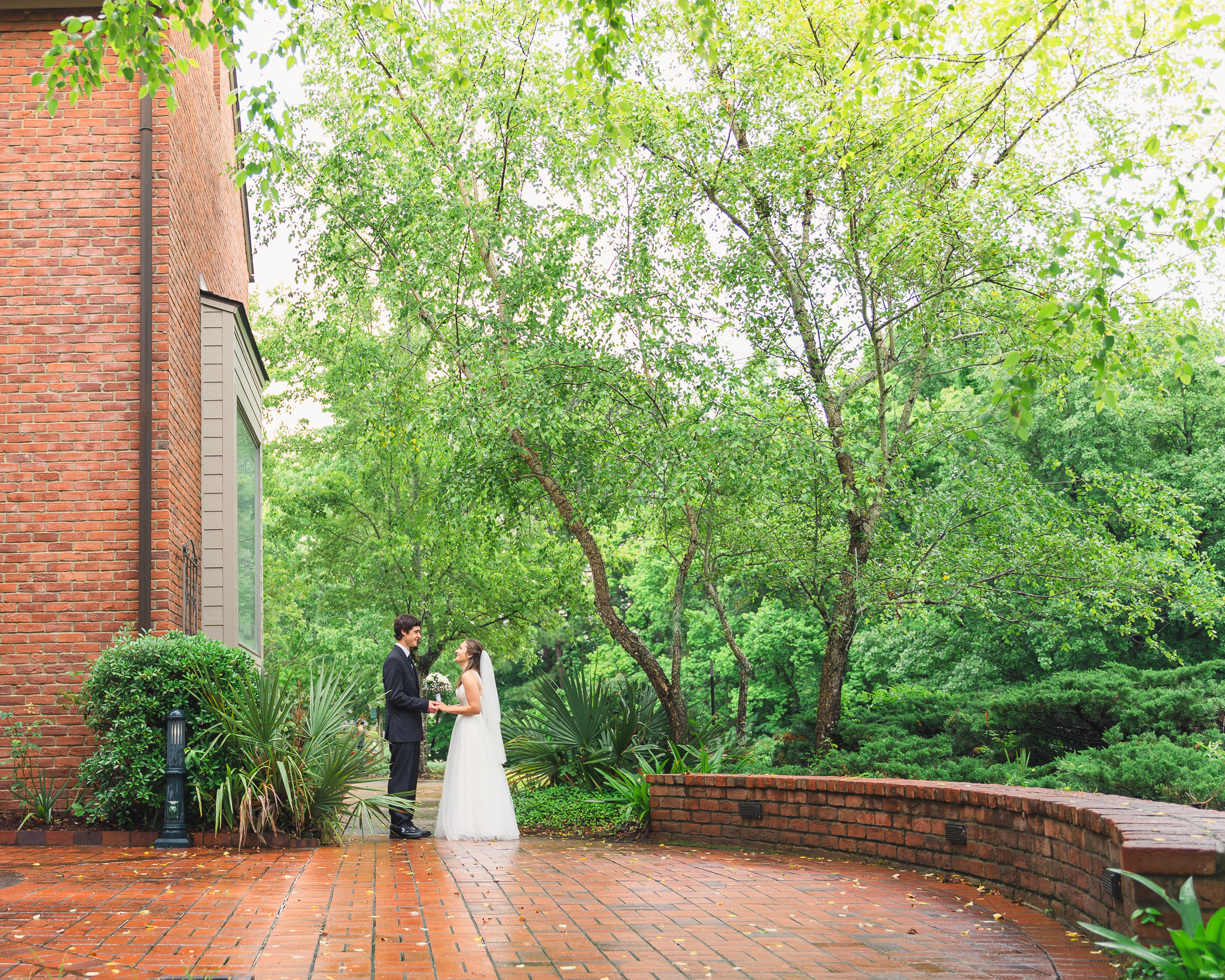 Bride and Groom standing hand in hand at an outdoor wedding venue in Clinton, MS