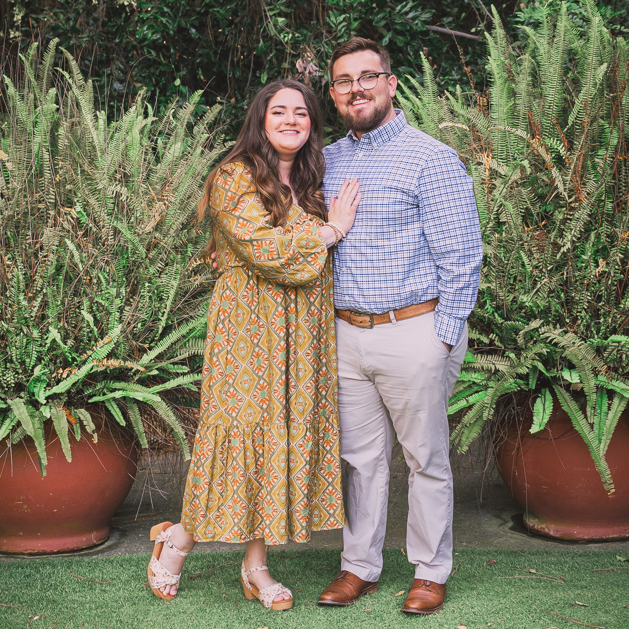 Man and woman posing in a garden together
