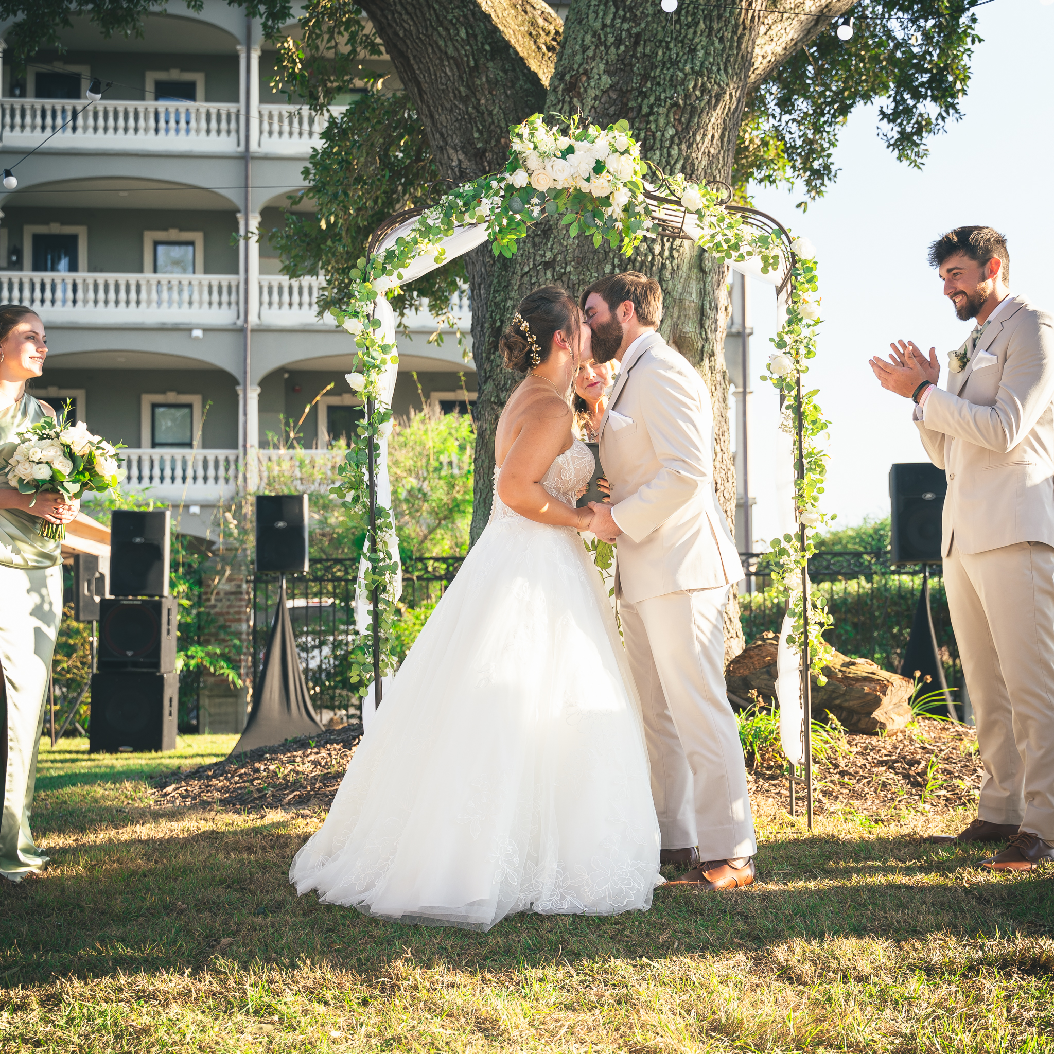 Bride and groom having their first kiss together at the alter in an outdoor setting